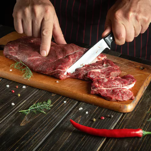 cook-cuts-raw-fresh-beef-meat-cutting-board-before-baking-barbecue.jpg