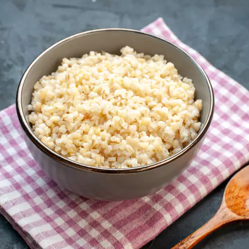 front-view-cooked-pearl-barley-inside-plate-dark-surface.jpg