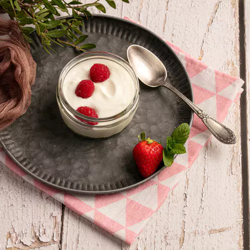 yoghurt-with-raspberries-metal-plate-white-wooden-table.jpg